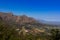 Beautiful mountainous landscape from a moving car driving on a tar road, Cape Town