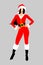 Beautiful Mrs. Santa Claus with black long hair in a red jumpsuit with white fur and black high heels. Christmas character