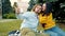 Beautiful multi-ethnic couple having fun outdoors taking selfie with smartphone