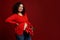 Beautiful multi ethnic pregnant woman smiling at camera, posing with a bouquet of red tulips for Mother's or