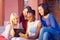 Beautiful multiracial female friends socializing through the internet on tablet