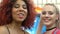 Beautiful multiracial pierced female friends laughing on camera, happiness