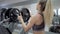 Beautiful muscular girl is getting ready to perform a barbell exercise
