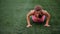 A beautiful muscular girl in pantyhose and a vest makes a burpee at the stadium. Crossfit, fitness, healthy lifestyle