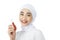 beautiful muslim girl in hijab looking at camera while holding lipstick bottle