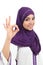 Beautiful muslim woman wearing a hijab gesturing ok