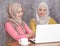 beautiful muslim women presenting something on laptop to her sib