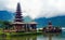 Beautiful mystic moody  spiritual landscape, lake island, old hindu temple, mountains, deep misty clouds - Pura Ulun Danu Batur