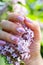 Beautiful nails with lilac flowers and fresh flowers