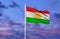 Beautiful national state flag of Kurdistan fluttering at sky background.