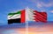 Beautiful national state flags of UAE United Arab Emirates and Bahrain together at the sky background.