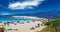 Beautiful natural crowded lagoon sand beach, kite surfers, dune, hill, blue sky
