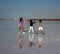 Beautiful and natural scene kids playing at salt lagoon in small island coche Margarita Venezuela