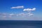 Beautiful natural sea landscape in sunny day. Beauty world, blue sky with white clouds. Deep blue backdrop, background wallpaper