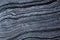 A beautiful natural stone background of gray marble with dark stripes is called Silver Wave