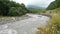 Beautiful Natural Torrent of a Stormy Mountain River. Flash Flood Muddy River. Rushes River Raging Fast Flowing Water