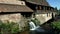 Beautiful natural waterfall on small river in Alsace village
