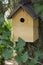 Beautiful natural wooden birdhouse in the garden