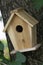 Beautiful natural wooden birdhouse in the garden