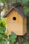 Beautiful natural wooden birdhouse in the garden