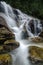 Beautiful in nature, amazing cascading tropical waterfall. wet and mossy rock