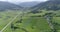 Beautiful nature in drone view, auto road among green fields and forests