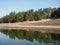 Beautiful nature landscape green forest of pine tree reflect on the water surface, lake backwater at dawn peaceful waterfront camp