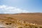 Beautiful nature landscape in high atlas mountains in Morocco. Yellow and brown grassy field against hills