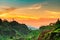 Beautiful nature landscape of mountain range with sunset sky and clouds. Mountain valley in Thailand. Scenery of mountain layer