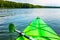 Beautiful nature scene on lake with green kayak.