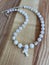 A beautiful necklace of mother-of-pearl and moonstone on a wooden background