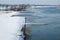 Beautiful Nederrijn river surrounded by fluffy white snow under the clear sky in Holland