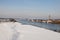 Beautiful Nederrijn river surrounded by fluffy white snow under the clear sky in Holland