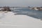 Beautiful Nederrijn river surrounded by fluffy white snow under the clear sky in Holland