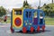 Beautiful new modern playground in kindergarten with soft rubber flooring, bright new multicolored big toy car and seesaw on brigh