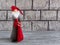 Beautiful New Year composition - New Year`s lights, Santa Claus or gnome with a bag of gifts on a concrete background