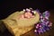 Beautiful newborn baby girl with a purple wreath sleeps in a wicker basket