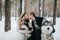 Beautiful newlyweds are kissing on background of husky. Winter wedding. Artwork