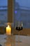 Beautiful night with candlelight and wine. Romantic warm decoration. Evening relaxation in the dark. A glass of tasty red wine