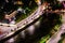 A beautiful night city with bridges and rivers. Driving cars at an intersection with a traffic light. Beautiful night cityscape