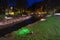 Beautiful night cityscape of a landscaped canal and illuminated walking bridge in the background