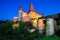 Beautiful night panorama of the Hunyad Castle / Corvin`s Castle with wooden bridge