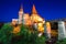 Beautiful night panorama of the Hunyad Castle / Corvin`s Castle with wooden bridge