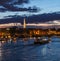 Beautiful night Paris, sparkling Eiffel tower, bridge Pont des Arts over the River Seine and touristic boats. France