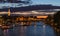 Beautiful night Paris, sparkling Eiffel tower, bridge Pont des Arts over the River Seine and touristic boats. France