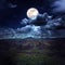 Beautiful night sky with cloudy and full moon above mountain ran