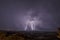 Beautiful night sky with lightning and thunderbolts during a thunderstorm in the countryside