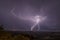 Beautiful night sky with lightning and thunderbolts during a thunderstorm in the countryside