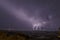 Beautiful night sky with lightning and thunderbolts during a thunderstorm in the countryside