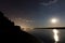 Beautiful night sky with moon and constellation over Danube river